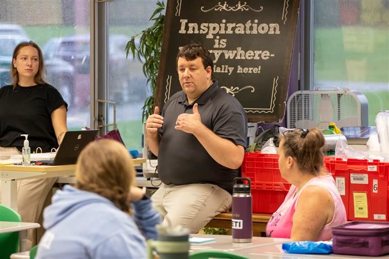  An instructor presents to a group of teaching assistants